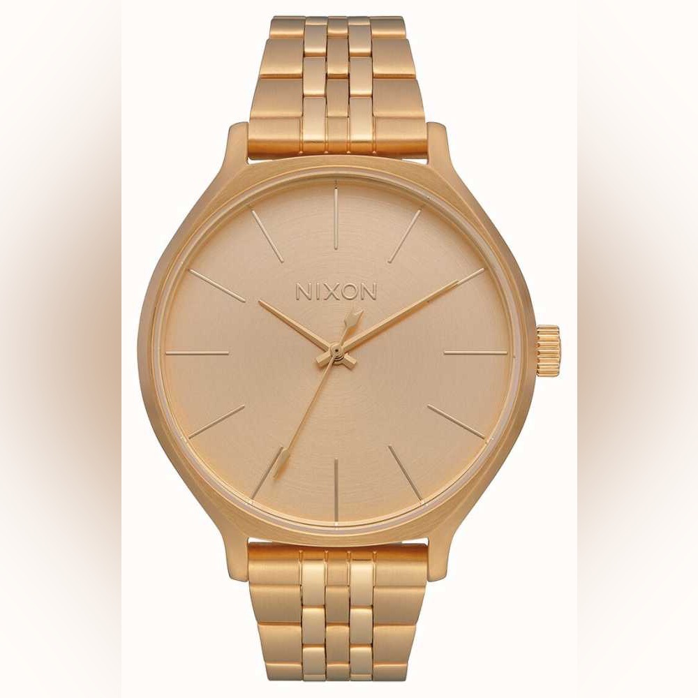 Nixon strainless steel watch in gold